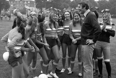 Malcom Allison gives a team talk to Playboy Club Bunnies before a charity match